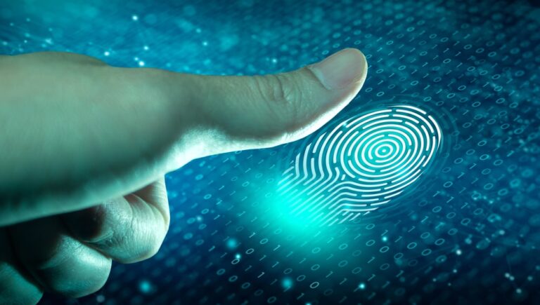 Image is of a person pressing a finger onto a digital scanner, representing fingerprint checks used during background screening and verification procedures.